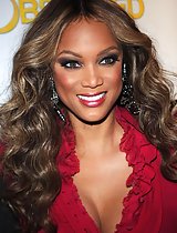 Americas next top model Tyra Banks on show with hot and deep cleavage performing massage