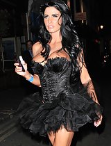 Katie Price showing off her massive cleavage in a black mini dress in these pivs