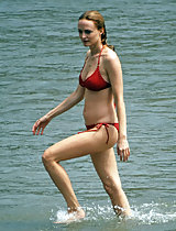 Heather Graham spreads her legs in a red polkadot bikini at the beach in these pics