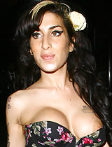 Amy Winehouse's newly-done tits popping out of her busty dress in these pics