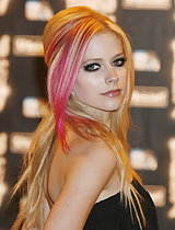 Avril Lavigne looking sexy in a long black dress on the red carpet in these pics