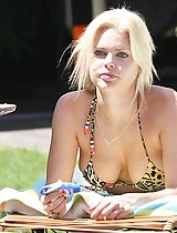 Sophie Monk's sweet cleavage and mile-long legs surfing at the beach in these pics